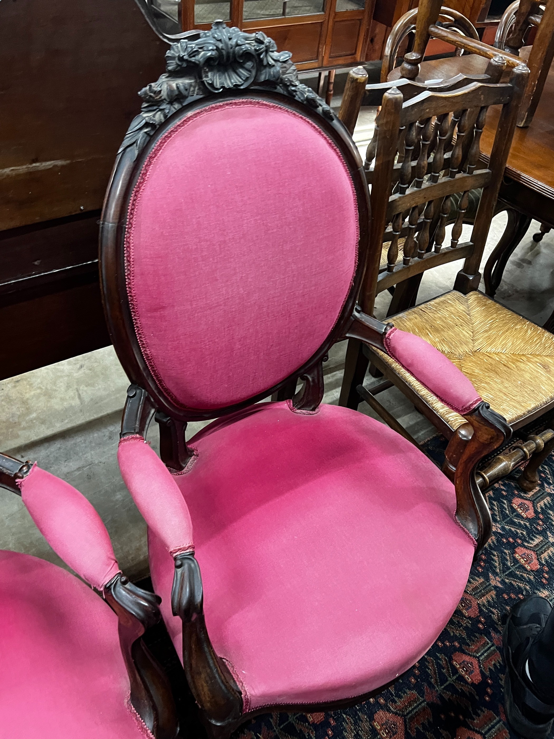 A near pair of 19th century French rosewood upholstered armchairs, larger width 61cm, depth 56cm, height 108cm